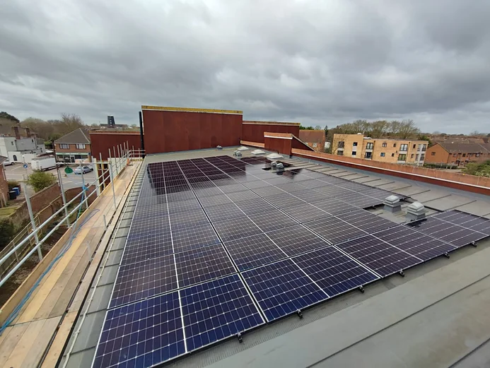Solar panels installed on a commercial building roof, showcasing sustainable energy solutions and potential cost savings for businesses.
